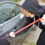 Person breaking into a car