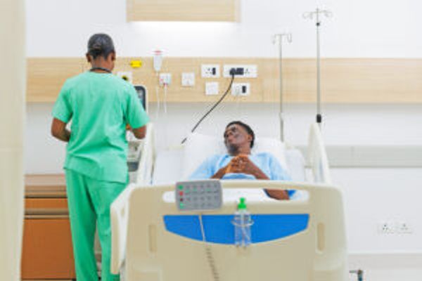 Nurse and man in hospital bed