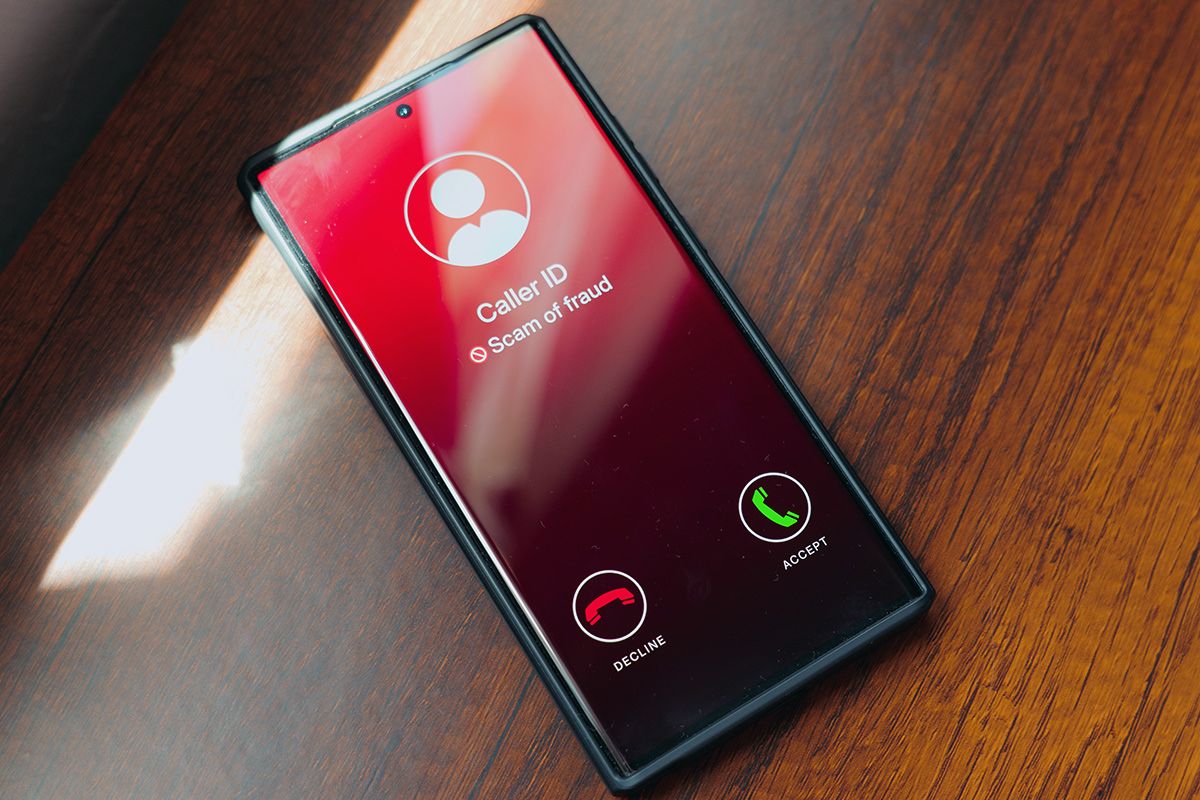 Phone with caller ID reading "scam"