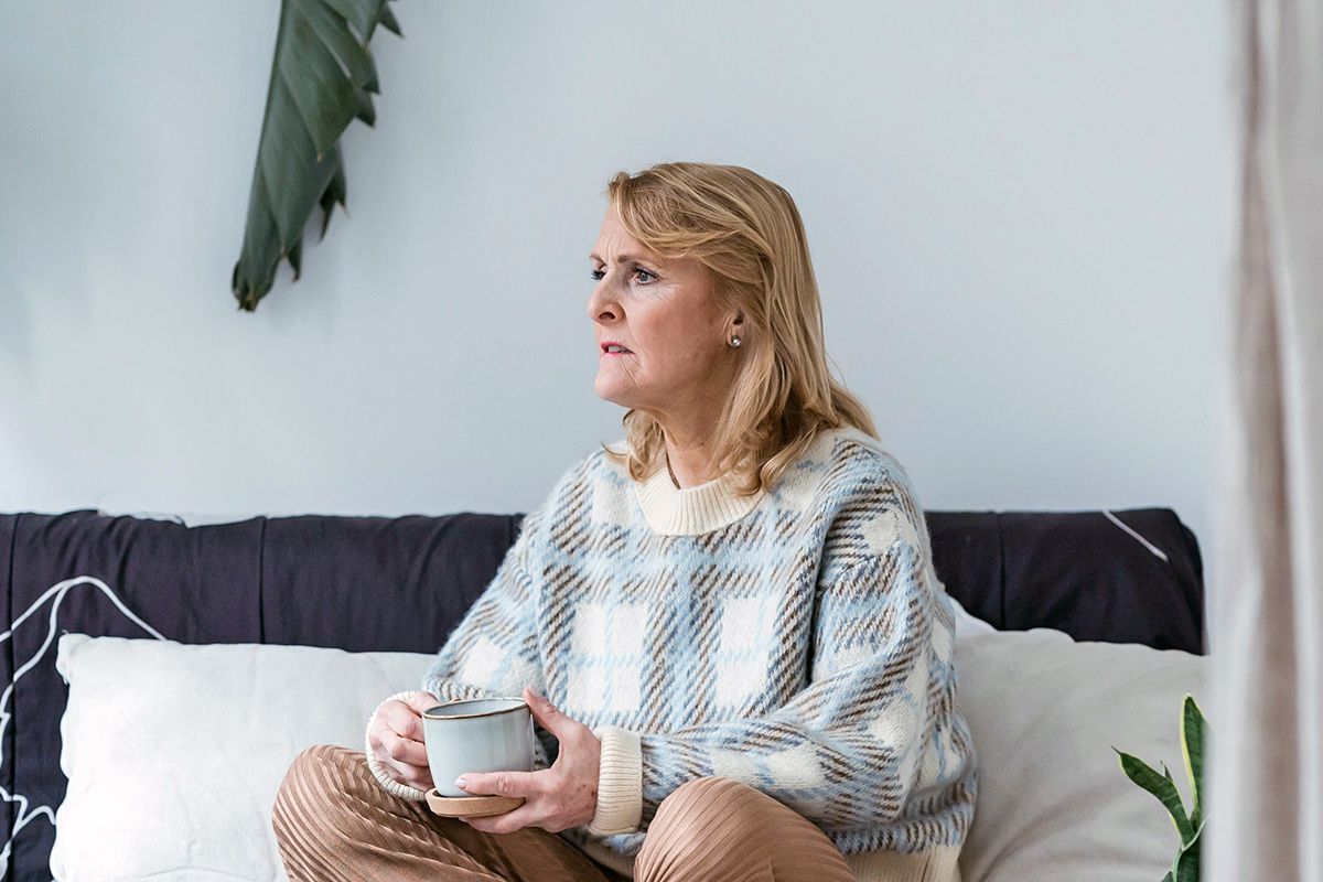 Woman holding mug and looking into the distance