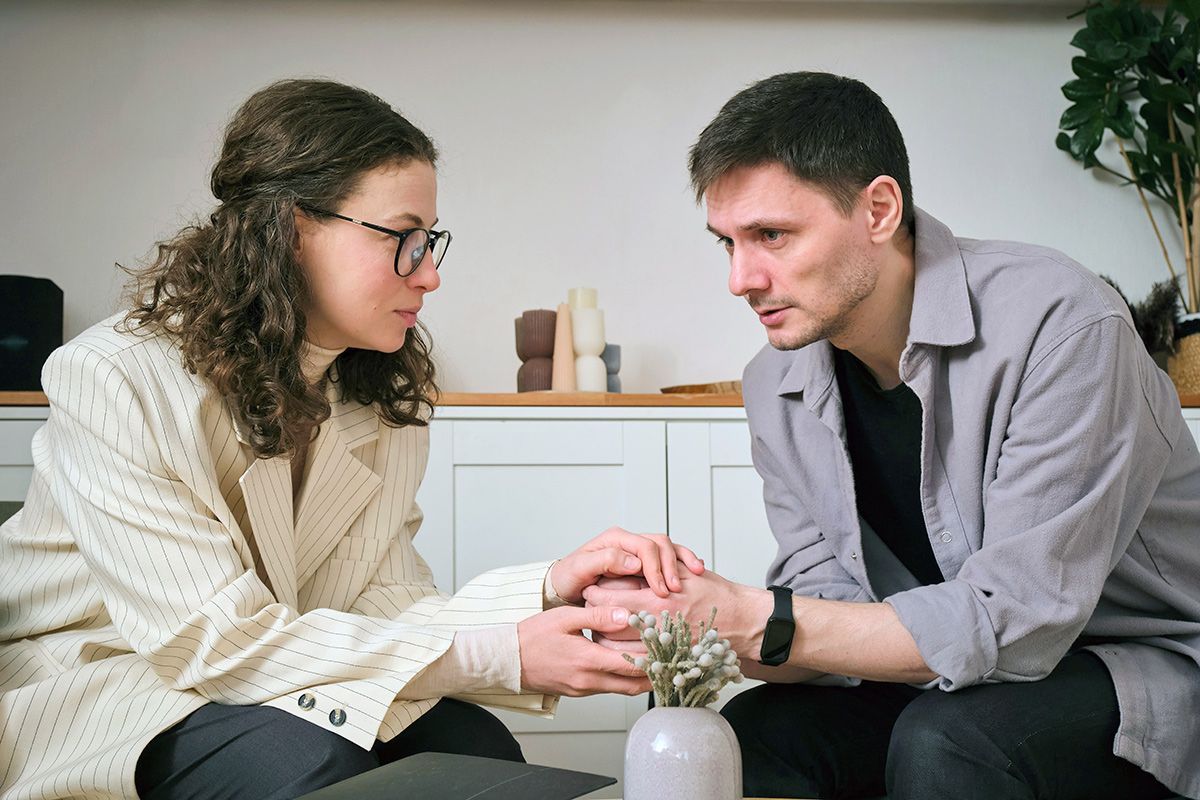 Woman holding man's hand
