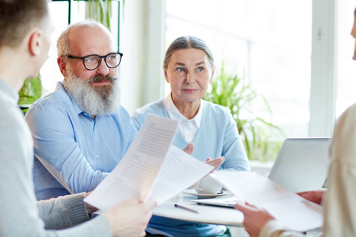 Older couple meeting with planners