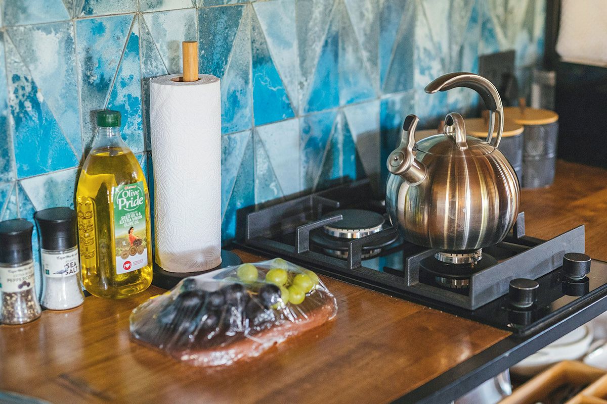 Olive oil and paper towels next to a stove