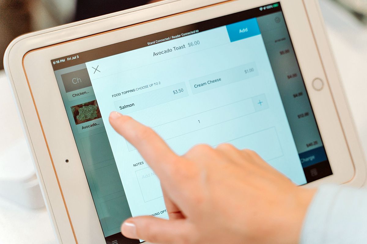 Person ordering food on a touchscreen