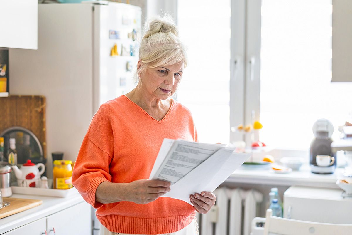 Older woman looking at bill