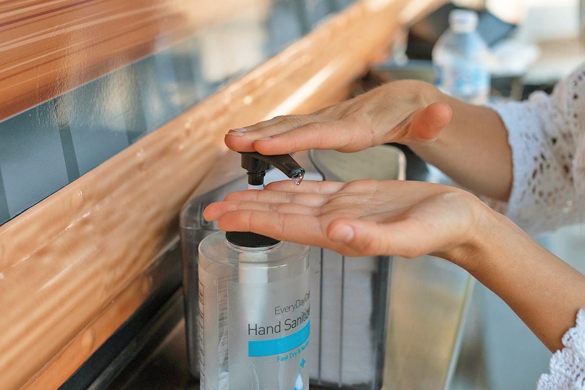 Pumping hand sanitizer into hand