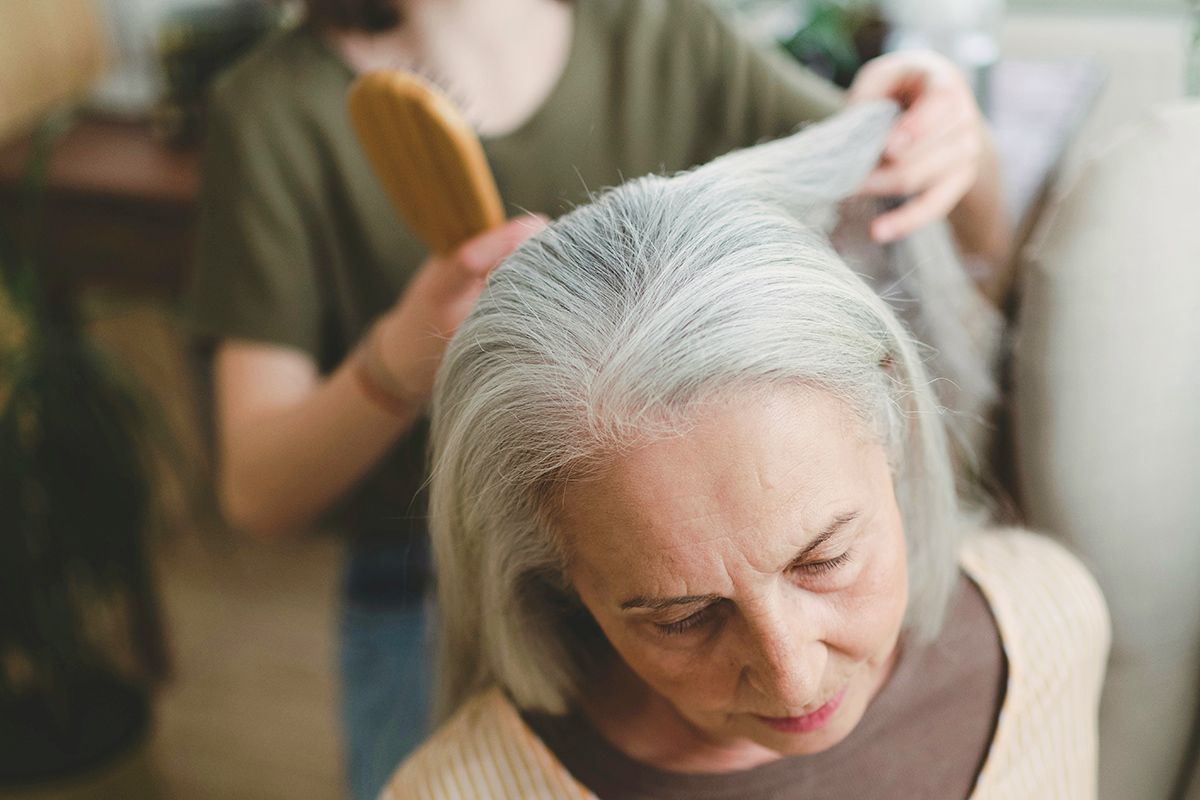 Brushing an older person's hair