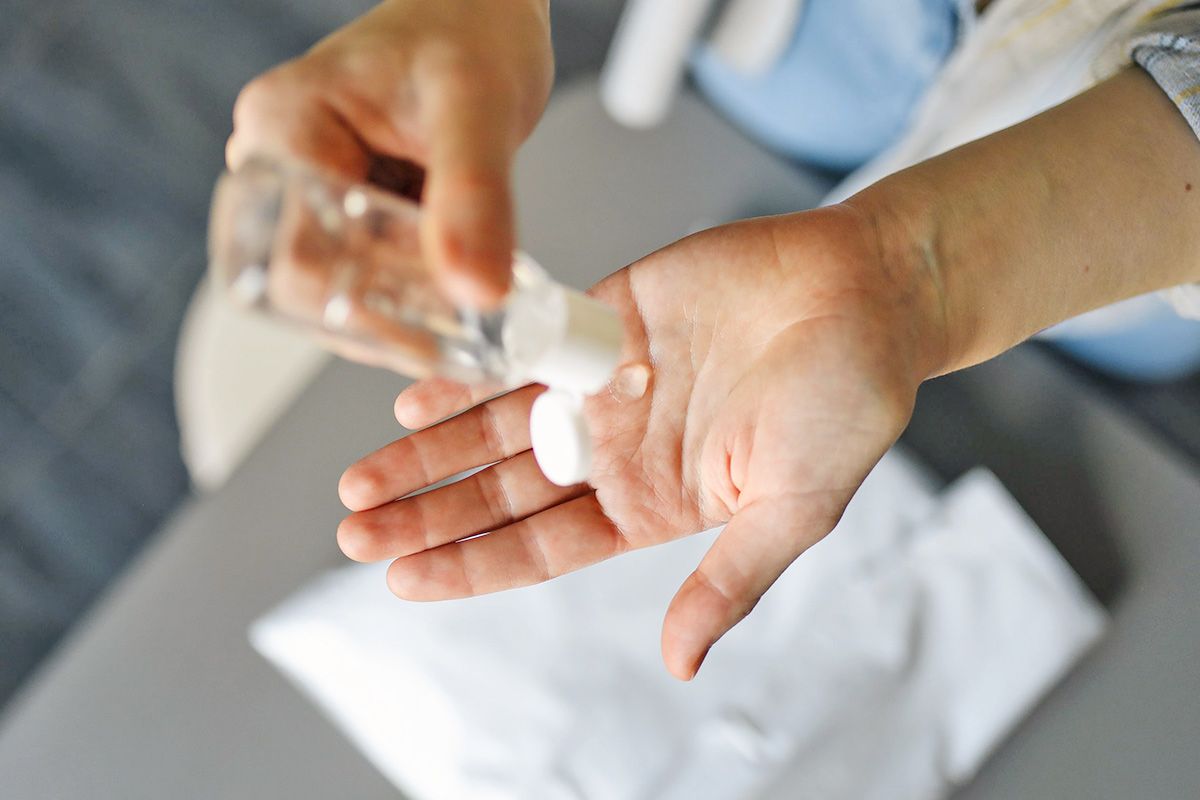 Putting hand sanitizer in hand