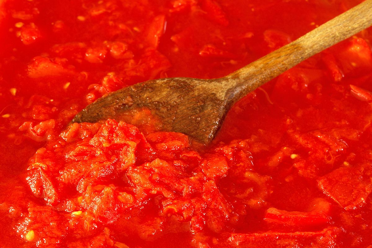 Tomato sauce with a spoon in it