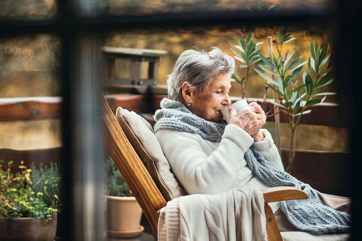 Older person wrapped in blankets
