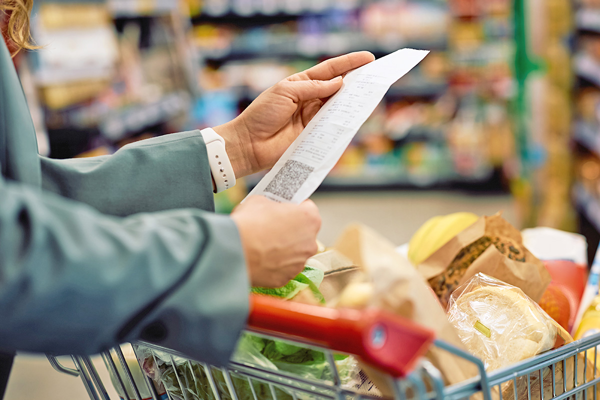 Person looking at grocery receipt
