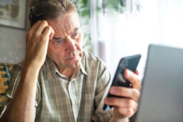 Confused man looking at phone