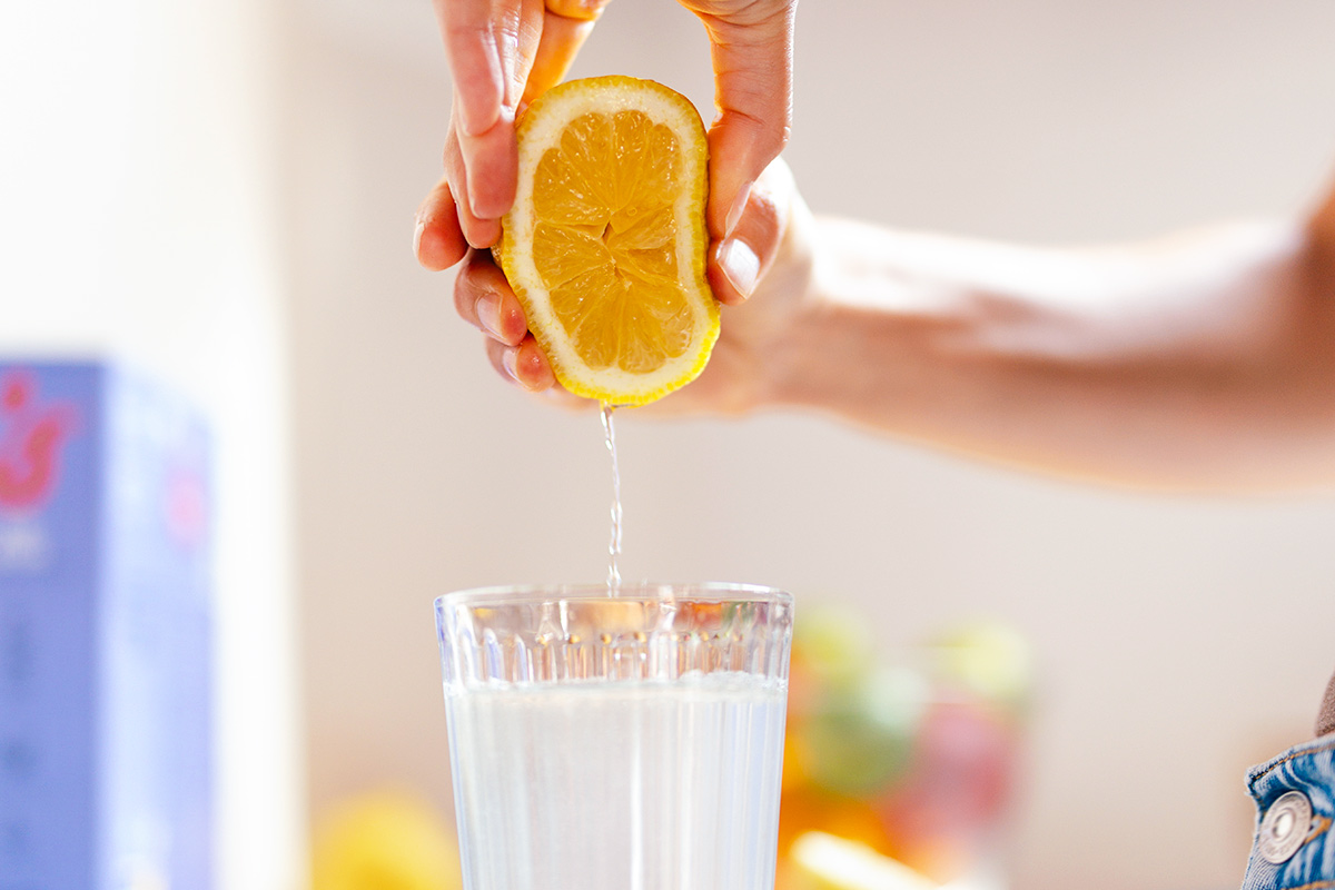 Squeezing orange into glass