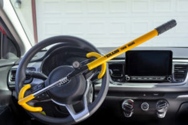 The Club in yellow on a steering wheel