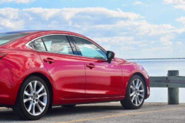 Red car by water